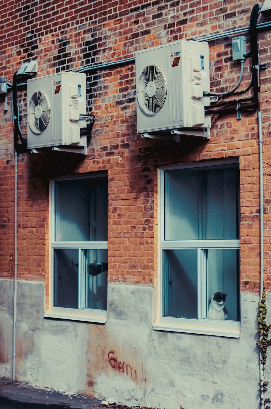 Outdoor air conditioning equipment mounted on a brick wall